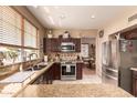 Bright kitchen with granite counters, stainless appliances, and convenient breakfast nook at 7103 E Medina Ave, Mesa, AZ 85209