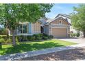 Well-maintained single-story home with a green lawn, mature trees, and an attached two-car garage at 7149 E Plata Ave, Mesa, AZ 85212