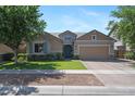 Charming single-story home with a well-manicured lawn and a two-car garage, showcasing inviting curb appeal at 7149 E Plata Ave, Mesa, AZ 85212