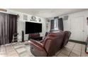 Comfortable living room setup with a large TV and a relaxing recliner sofa at 7506 N 47Th Dr, Glendale, AZ 85301