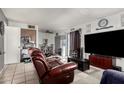 Open-concept living space with a large TV and sliding glass doors to the backyard at 7506 N 47Th Dr, Glendale, AZ 85301