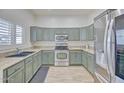 Bright kitchen showcasing sleek appliances, ample cabinet space, and stone countertops at 7978 W Zoe Ella Way, Peoria, AZ 85382