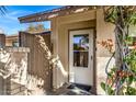 Inviting front entryway featuring a white door, tiled floor, and lush bougainvillea at 8616 E Diamond St, Scottsdale, AZ 85257