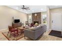 Cozy living room with stone fireplace, wood floors, and neutral walls at 8616 E Diamond St, Scottsdale, AZ 85257