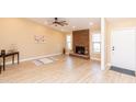 Bright and airy living room featuring wood flooring and a charming stone fireplace at 8616 E Diamond St, Scottsdale, AZ 85257