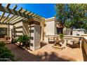 Inviting courtyard with a fountain, seating area, and lush greenery for outdoor relaxation at 9012 S 47Th Pl, Phoenix, AZ 85044