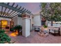 Inviting courtyard with a fountain, seating area, and lush greenery lit at dusk at 9012 S 47Th Pl, Phoenix, AZ 85044