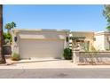Charming single-story home featuring a two-car garage and a landscaped front yard on a bright, sunny day at 9012 S 47Th Pl, Phoenix, AZ 85044