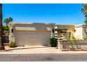 Exterior shot of a home featuring a spacious two-car garage and landscaped yard at 9012 S 47Th Pl, Phoenix, AZ 85044