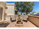 Cozy patio area with comfortable seating surrounding a charming water fountain for outdoor relaxation at 9012 S 47Th Pl, Phoenix, AZ 85044