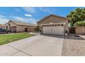Lovely one-story home with two-car garage, wide driveway, desert landscaping, and easy maintenance yard at 9463 W Ross Ave, Peoria, AZ 85382
