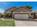 Beige one-story home featuring a two-car garage, desert landscaping, and a well-maintained yard at 9463 W Ross Ave, Peoria, AZ 85382