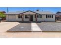 Charming home featuring a gravel yard, brick-accented posts, and a welcoming front entrance at 119 E Hampton Ave, Mesa, AZ 85210