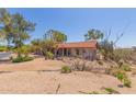 Single-story home boasts a tile roof and low-maintenance desert landscaping at 1305 Coyote Pass Pass, Carefree, AZ 85377