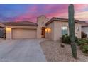 Single-story desert home with a tile roof, two-car garage, and native landscaping in a peaceful setting at 13569 S 175Th Dr, Goodyear, AZ 85338