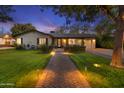 Inviting home with a brick pathway leading to a modern front door and a well-maintained lawn, beautifully lit at twilight at 141 E Bonita Way, Tempe, AZ 85281