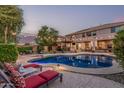Beautiful outdoor space featuring a sparkling pool, lounge chairs and pergola with string lights at 14294 W Edgemont Ave, Goodyear, AZ 85395