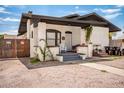 Charming home featuring a stucco exterior, covered porch, and low-maintenance gravel landscaping at 1505 W Fillmore St, Phoenix, AZ 85007