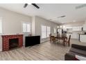 Inviting living space featuring neutral walls, wood-look floors, and a cozy brick fireplace at 1505 W Fillmore St, Phoenix, AZ 85007