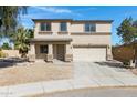 Inviting two-story home featuring a well-manicured front yard and a two-car garage at 1612 E Desert Rose Trl, San Tan Valley, AZ 85143