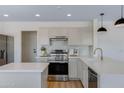 Modern kitchen featuring stainless steel appliances, light cabinetry, and quartz countertops at 1612 E Desert Rose Trl, San Tan Valley, AZ 85143