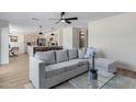 Open-concept living room with contemporary furnishings and adjacent kitchen at 1612 E Desert Rose Trl, San Tan Valley, AZ 85143