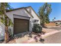 Front exterior with a two-car garage and desert landscaping at 1822 S 39Th St # 7, Mesa, AZ 85206