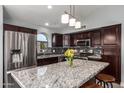 Modern kitchen featuring granite countertops, stainless steel appliances, and a stylish tile backsplash at 18643 N 73Rd Ave, Glendale, AZ 85308