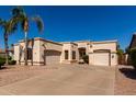 Single-story home featuring a three-car garage and desert landscaping at 1865 S Morrison Ln, Gilbert, AZ 85295