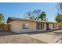 Inviting single-story home featuring a neutral color scheme, long driveway, and xeriscaped yard at 1919 W Fairmount Ave, Phoenix, AZ 85015