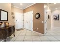 Inviting foyer featuring tiled flooring, neutral paint, and decorative accents at 20473 N Desert Sage Ln, Surprise, AZ 85374