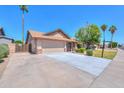 Spacious driveway leading to a two-car garage, complemented by a well-kept front yard at 2322 E Dolphin Ave, Mesa, AZ 85204