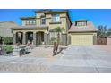 Expansive home featuring manicured landscaping, a multi-car garage, and mature palm trees at 248 S 167Th Dr, Goodyear, AZ 85338