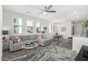 Bright living room featuring a comfortable sofa, decorative rug, and large windows that bring in natural light at 2511 W Queen Creek Rd # 262, Chandler, AZ 85248