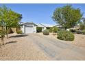 A charming single-story house featuring a long driveway leading up to a one car garage at 3106 W Mohawk Ln, Phoenix, AZ 85027