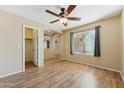 Comfortable bedroom with wood floors and a view to the hallway at 3370 E Flamingo Ct, Gilbert, AZ 85297