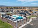Aerial view of a Primary-planned community showcasing a pool, clubhouse, playground, and neighborhood at 3626 E Audrey Dr, San Tan Valley, AZ 85143