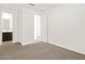 Bright bedroom featuring soft carpet and ensuite bathroom at 37111 W Prado St, Maricopa, AZ 85138