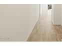 Bright hallway featuring stylish neutral tile flooring and crisp white walls at 37112 W Prado St, Maricopa, AZ 85138