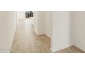 Clean hallway with neutral tile floors and white walls, offering a minimalist aesthetic at 37112 W Prado St, Maricopa, AZ 85138