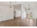 Bright living room with high ceilings, modern lighting, and a seamless flow to the outdoor area at 4007 W Thunderbird Rd, Phoenix, AZ 85053