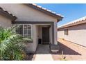Inviting front porch with a decorative security door and lush tropical plants at 4232 N 112Th Ln, Phoenix, AZ 85037