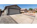 A well-maintained garage and driveway enhance the curb appeal of this home at 4232 N 112Th Ln, Phoenix, AZ 85037