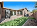 A private backyard featuring a paver patio, turf, and partial fencing at 4646 E Maplewood St, Gilbert, AZ 85297