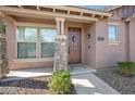 Inviting front entrance featuring a stone pillar, a wreath-adorned front door, and a well-maintained landscape at 4646 E Maplewood St, Gilbert, AZ 85297