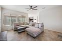 Cozy living room featuring a comfortable sectional sofa, decorative pillows, and an open floor plan at 4646 E Maplewood St, Gilbert, AZ 85297