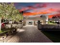 Striking contemporary home with manicured landscaping and desert sunset view at 4835 E Onyx Ave, Paradise Valley, AZ 85253