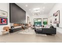 Open living room with modern fireplace, skylights, and backyard view at 4835 E Onyx Ave, Paradise Valley, AZ 85253