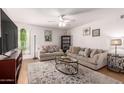 Comfortable living room with neutral tones, two sofas, a glass coffee table, and plenty of natural light at 4950 N Miller Rd # 200, Scottsdale, AZ 85251