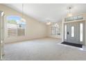 Spacious living room with carpet, large windows, and a decorative front door at 530 N Jesse Ct, Chandler, AZ 85225